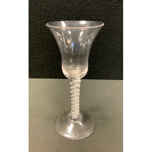 9 - An 18th Century air twist stem wine glass, bell-shaped bowl, multi helix opaque stem,  17cm high, c.... 
