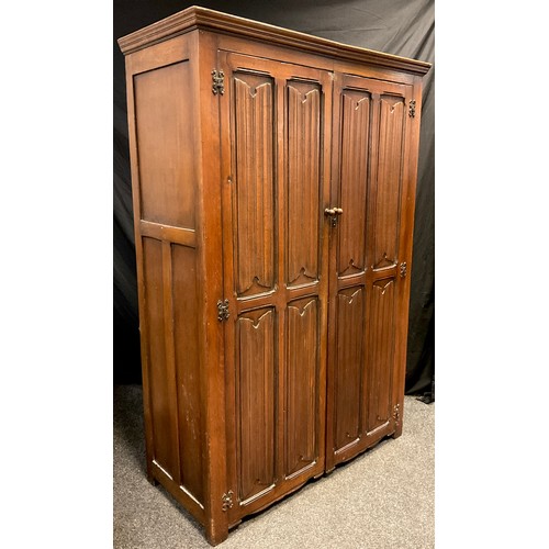 39 - A mid 20th century Goodall's of Manchester oak double wardrobe, moulded cornice above a pair of full... 