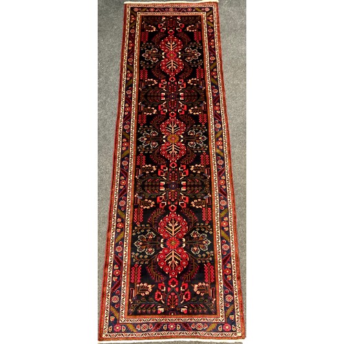 40 - A North West Persian Rudbar runner carpet, hand-knotted with a central field of three repeating flor... 