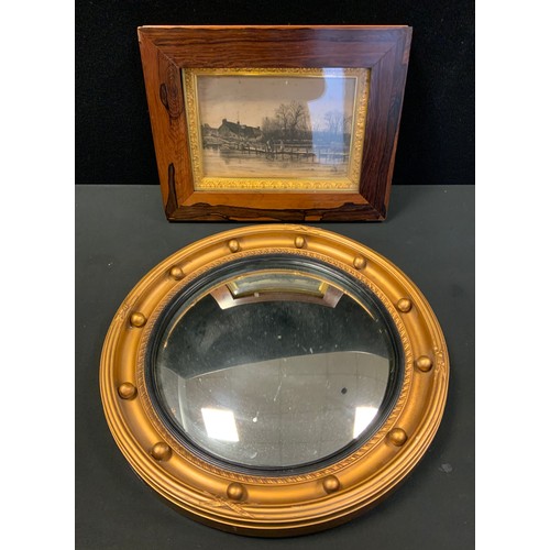 44 - A late 19th/early 20th century rosewood frame, framing a etching  ; a Regency style convex mirror (2... 