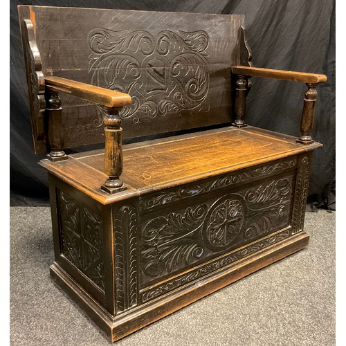 76 - An early 20th century carved oak Monk’s bench, 102cm (81.5cm) high x 106.5cm wide x 47cm deep.