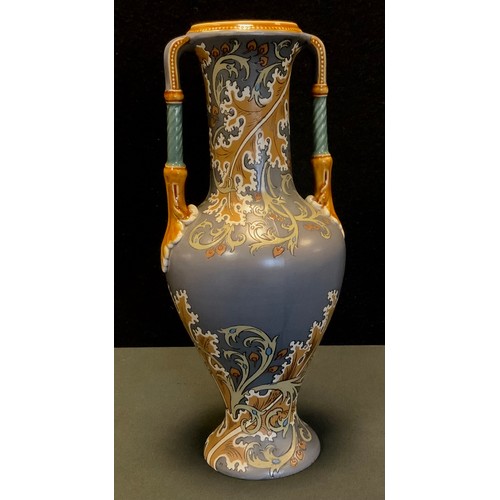 89 - A Mettlach baluster two handled vase decorated with foliate scrolls in ochre, on a grey ground, impr... 