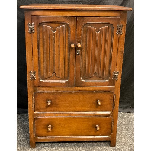 90 - A mid 20th century oak side cupboard, by Goodall's furniture of Manchester, over-sailing rectangular... 