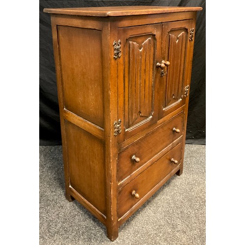 90 - A mid 20th century oak side cupboard, by Goodall's furniture of Manchester, over-sailing rectangular... 