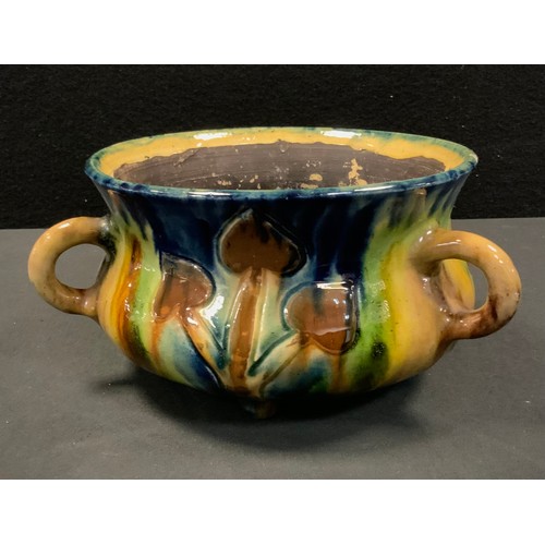 92 - A West German majolica glaze tri-handled planter, art nouveau style, in tones of green, blue and yel... 