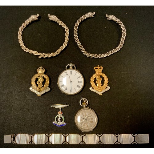 403 - Jewellery & Watches - two silver coloured metal mask head torc bangles, dragon mask terminals, rope ... 