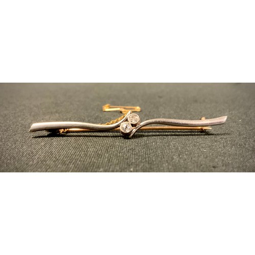 424 - A diamond cross crest bar brooch, set with two round brilliant cut diamonds, total estimated diamond... 