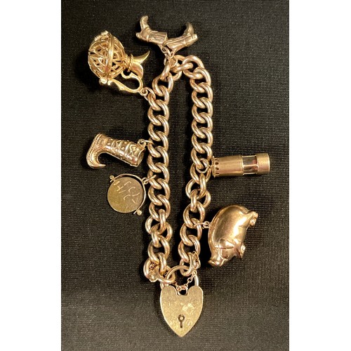 428 - A 9ct gold charm bracelet, padlock clasp, suspending six charms, Pig, Miners Lamp, pair of Cowboy Bo... 