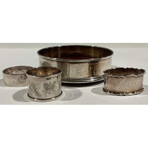48 - A silver wine bottle coaster, mahogany base, London 1998; a silver napkin ring, London 1975; other s... 