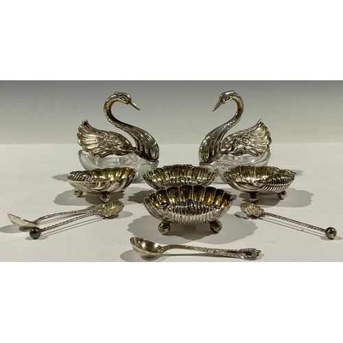 51 - A pair of Victorian silver scallop shell shaped table salts and spoons, three ball feet, Chester 189... 