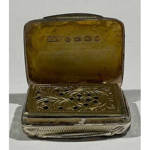 52 - A Victorian silver rounded rectangular vinaigrette, engraved with scrolling leaves, gilt interior wi... 