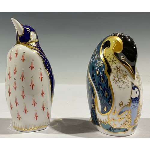 64 - A Royal Crown Derby paperweight, Penguin and Chick, gold stopper, boxed; another, Penguin, gold stop... 