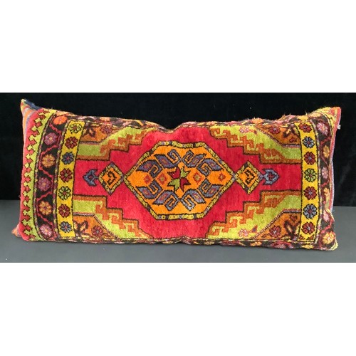 602 - A Middle Eastern woollen floor cushion, 110cm long