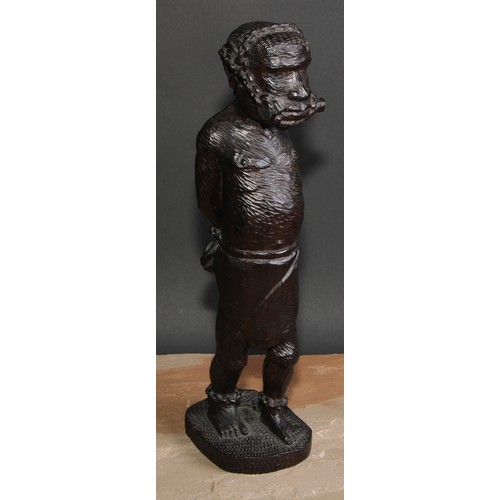 186 - Slavery - a West African tribal hardwood carving, of a slave in chains, 39cm high