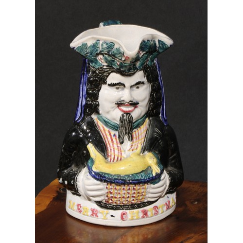 188 - A Staffordshire pearlware novelty toby jug, Merry Christmas, modelled as a bearded figure holding a ... 