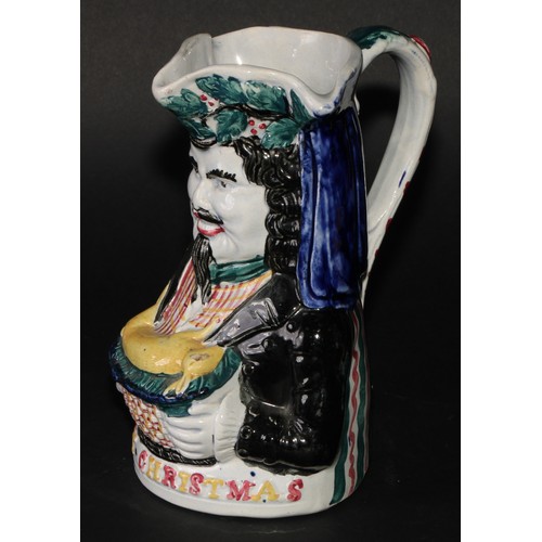 188 - A Staffordshire pearlware novelty toby jug, Merry Christmas, modelled as a bearded figure holding a ... 