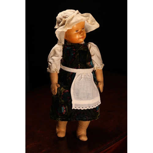 257 - An early 20th century Swiss carved wooden head doll, probably produced in the Brienz Region by Huggl... 