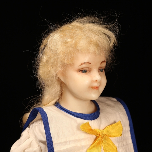 258 - A late 19th century poured wax shoulder head doll, the poured wax shoulder head with painted feature... 