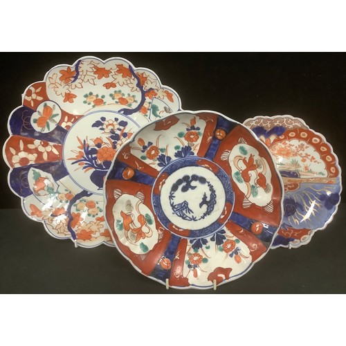 284 - A large Japanese Imari petal edge plate; a butterfly Imari and another