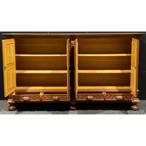 101 - A large Continental oak enclosed bookcase or side cabinet, oversailing rectangular top above two pai... 