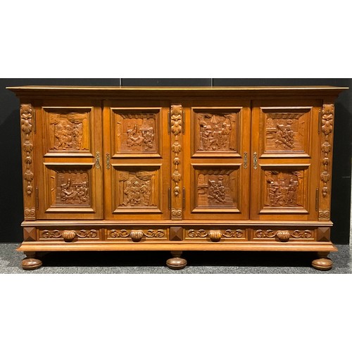 101 - A large Continental oak enclosed bookcase or side cabinet, oversailing rectangular top above two pai... 