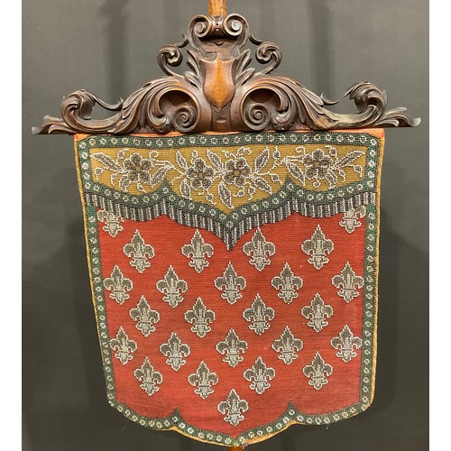 113 - An elaborate Victorian pole screen, with beadwork panel