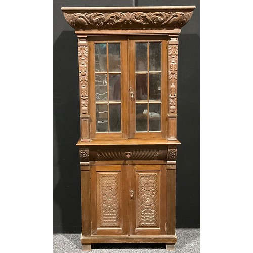 120 - An early 20th century oak library bookcase, carved throughout in the 17th century manner, 206.5cm hi... 