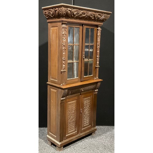 120 - An early 20th century oak library bookcase, carved throughout in the 17th century manner, 206.5cm hi... 