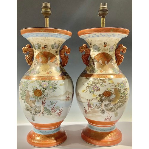 335 - A pair of Japanese Kutani two-handled vases, decorated with courtyard scene and fanciful birds, char... 