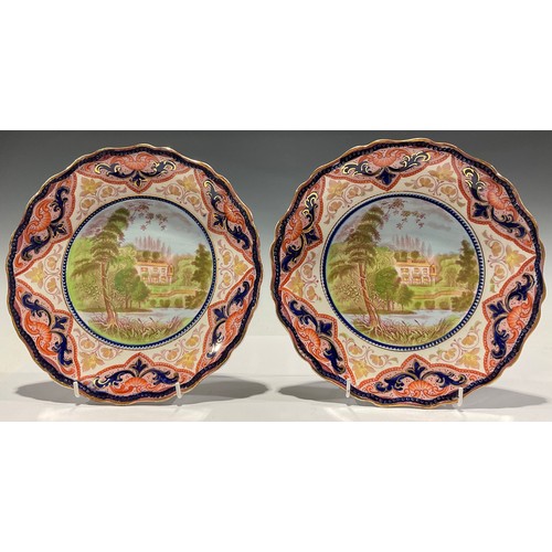 339 - A pair of Ruskin Burslem shaped circular plates, each depicting Ruskin's house, 24.5cm diam. C.1890