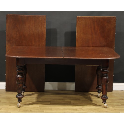 201 - A mahogany extending dining table, rounded rectangular top with two additional leaves, turned legs, ... 