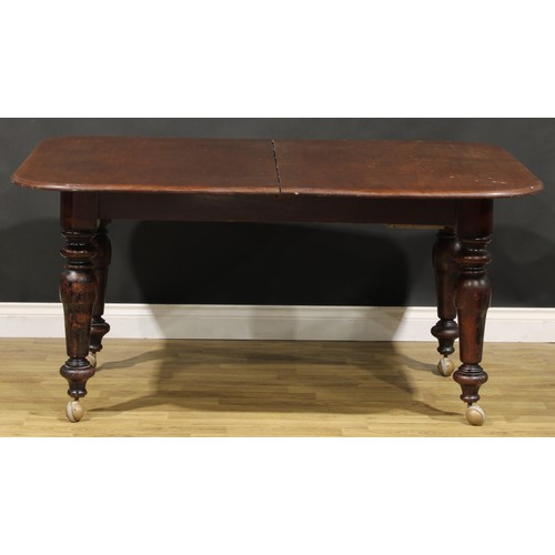 201 - A mahogany extending dining table, rounded rectangular top with two additional leaves, turned legs, ... 