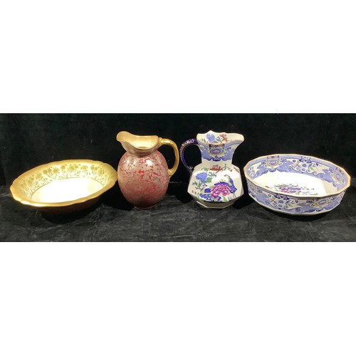 359 - A late Victorian Doulton Burslem wash jug and bowl, profusely decorated in silver with fanciful bird... 