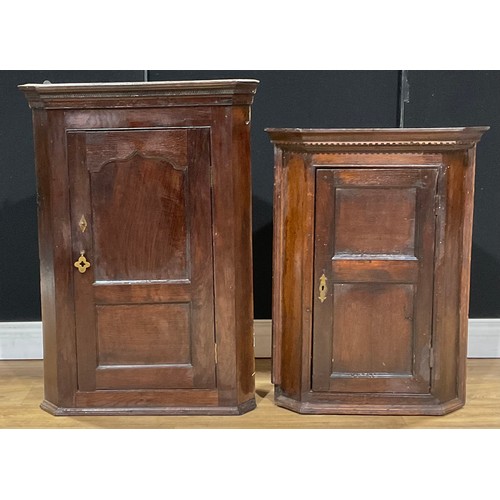 216 - A George III oak corner cabinet, 94cm high; another, slightly later and smaller, 80.5cm high (2)