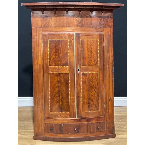 115A - A large George III mahogany bowfront corner cupboard, 131.5cm high, 96cm wide, 56cm deep