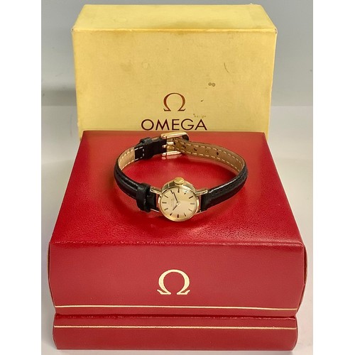 488 - A lady's Omega Automatic watch, gilt dial with baton indicators, black leather strap, boxed with pap... 