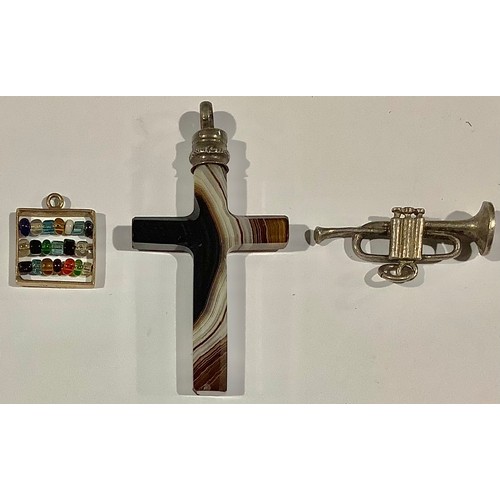 510 - A 9ct gold charm, as an abacus; an agate crucifix; a silver coloured metal charm, as a trumpet (3)