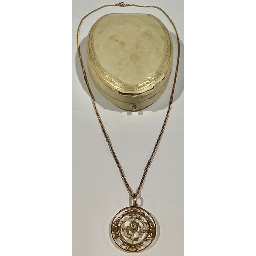 528 - A late Victorian 15ct gold openwork circular target pendant, the central faceted aquamarine stone su... 