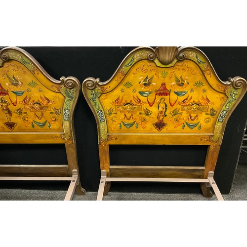 43 - A pair of carved and painted Venetian style single beds, the headboards with carved scallop cresting... 