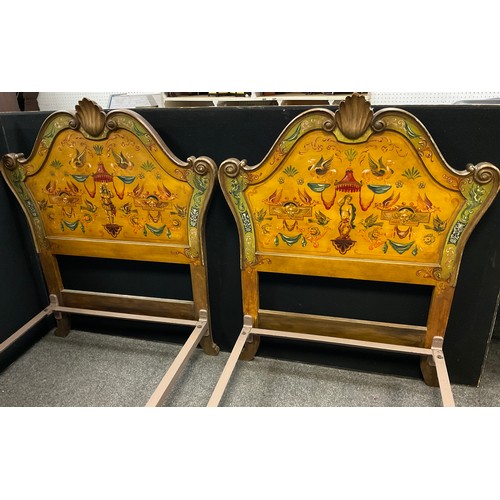 43 - A pair of carved and painted Venetian style single beds, the headboards with carved scallop cresting... 