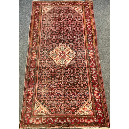 87 - A Persian Bidjar rug, hand-knotted with a central diamond-shaped medallion with stylised flowers, wi... 