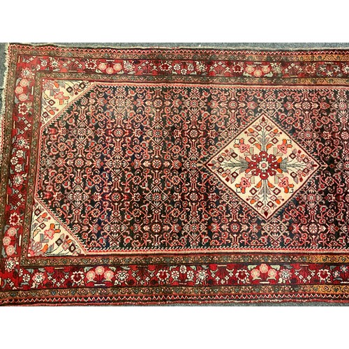 87 - A Persian Bidjar rug, hand-knotted with a central diamond-shaped medallion with stylised flowers, wi... 