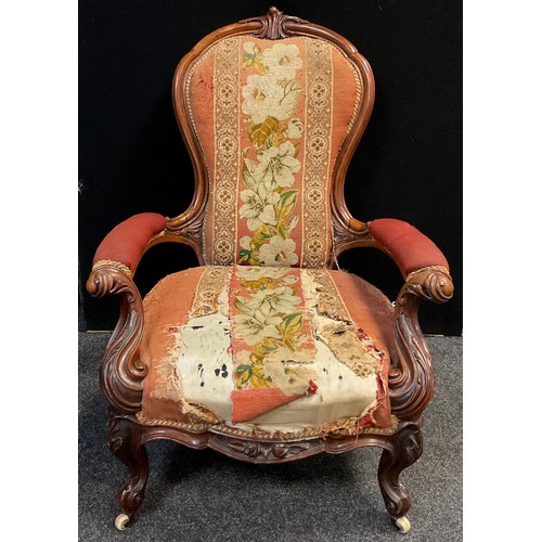 112 - A Victorian carved walnut armchair, stuffed-over back and arms, sprung seat, ornately carved scrolli... 