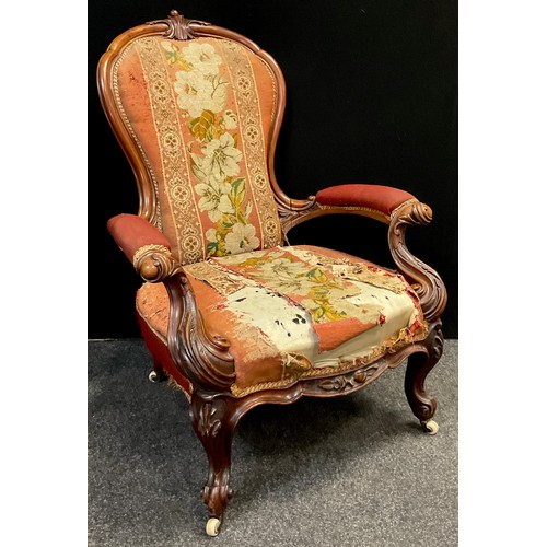 112 - A Victorian carved walnut armchair, stuffed-over back and arms, sprung seat, ornately carved scrolli... 