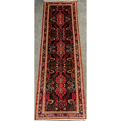 118 - A North West Persian Rudbar runner carpet, hand-knotted with a central field of three repeating flor... 