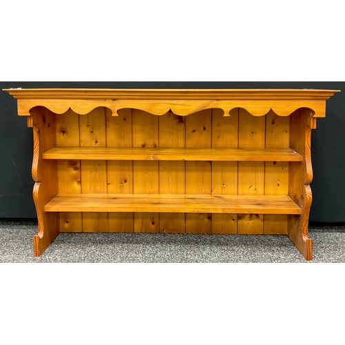 297 - A pine wall mounted dresser top, as a two-tier kitchen shelf, 63.5cm high x 114.5cm wide x 27.5cm.