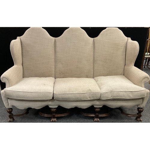 298 - An 18th century style Country House Wing-back three seat armchair sofa, 123cm high x 208cm wide x 89... 