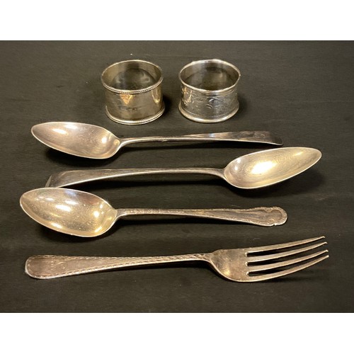 405 - Silver - A George III silver table spoon, London, 1804, silver napkin rings; etc, 152.0g in total