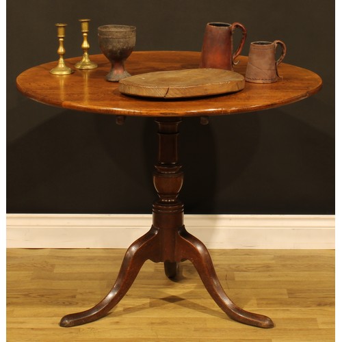 1536 - A George III oak tripod occasional table, circular tilting top, turned column, cabriole legs, pad fe... 