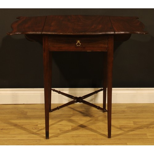 1302 - A George III mahogany butterfly Pembroke table, shaped top with fall leaves above a single frieze dr... 